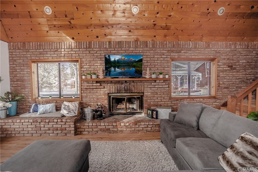 725 Temple Lane Big Bear Lake, CA 92315 - Photo 10 of 65 a living room with furniture a fireplace and a flat screen tv