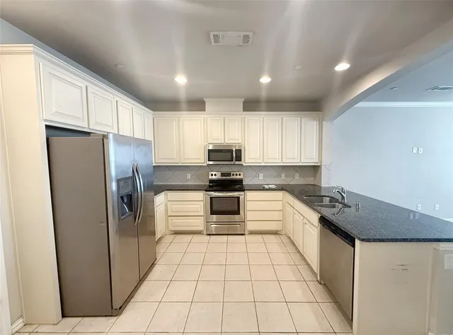 a bedroom with a bed and a potted plant