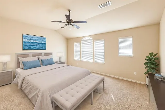 an empty room with a ceiling fan and a window