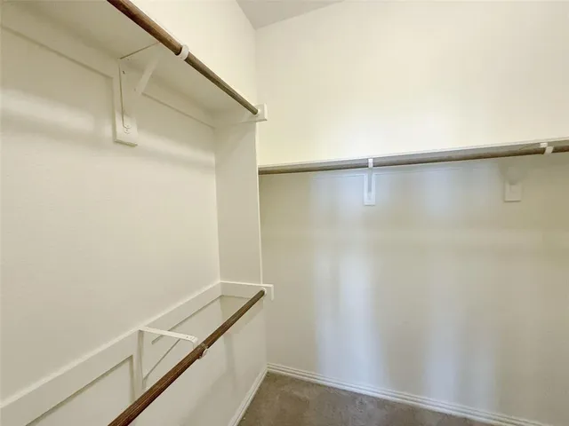 a spacious bathroom with a toilet sink and a mirror