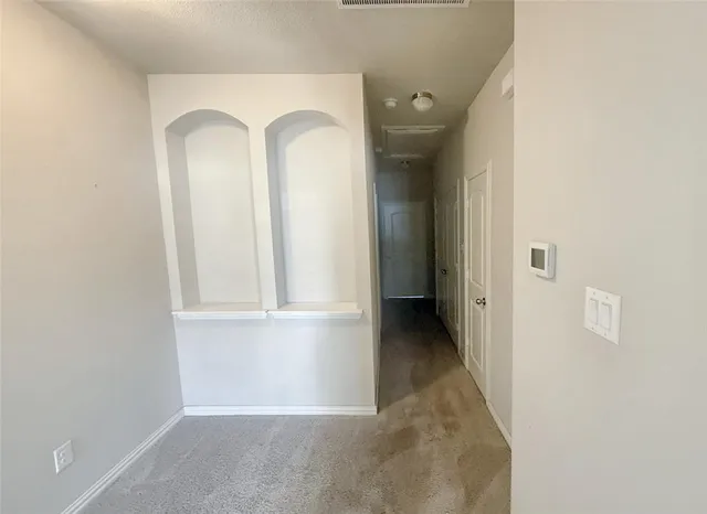 a spacious bedroom with a bed and a potted plant