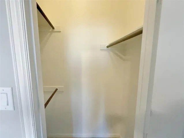 an empty room with windows and mirror