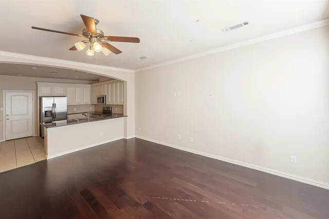 a view of a kitchen with a sink and a refrigerator