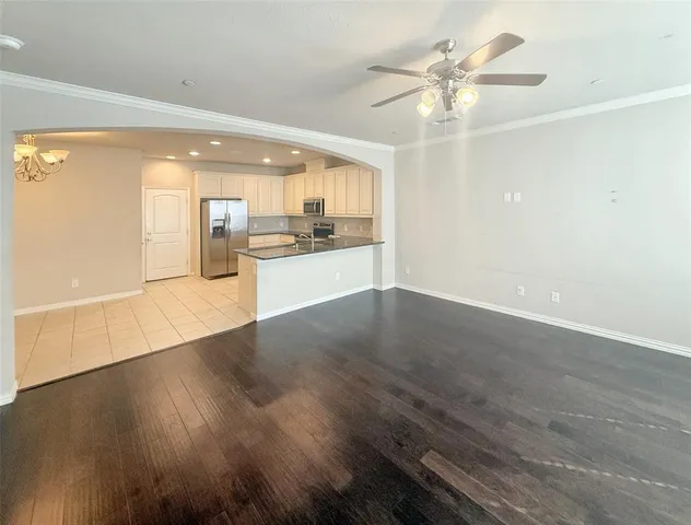 a kitchen with sink a microwave and cabinets