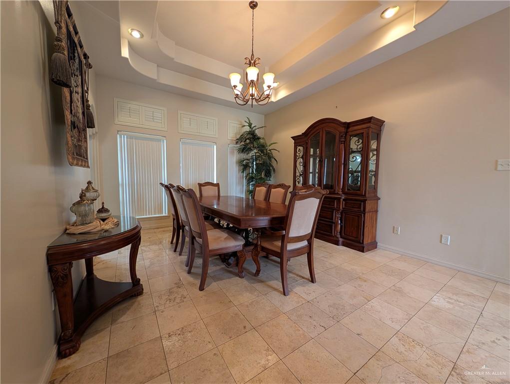 2000 East 25th Street Mission, TX 78574 - Photo 12 of 27 Dining room with a raised ceiling and a chandelier