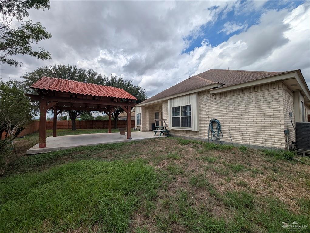 2000 East 25th Street Mission, TX 78574 - Photo 16 of 27 Back of house with a fenced backyard, a patio area, a pergola, and brick siding