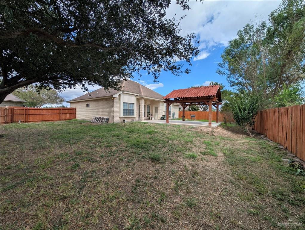 2000 East 25th Street Mission, TX 78574 - Photo 19 of 27 Fenced backyard featuring a patio area and a pergola