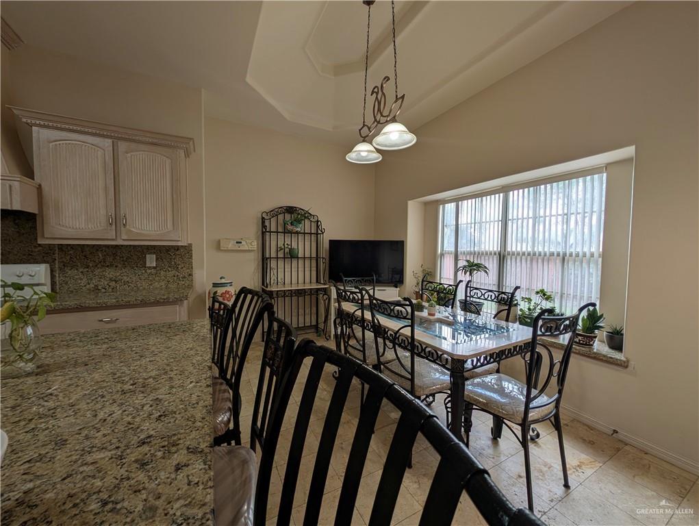 2000 East 25th Street Mission, TX 78574 - Photo 8 of 27 Dining room featuring baseboards and a raised ceiling