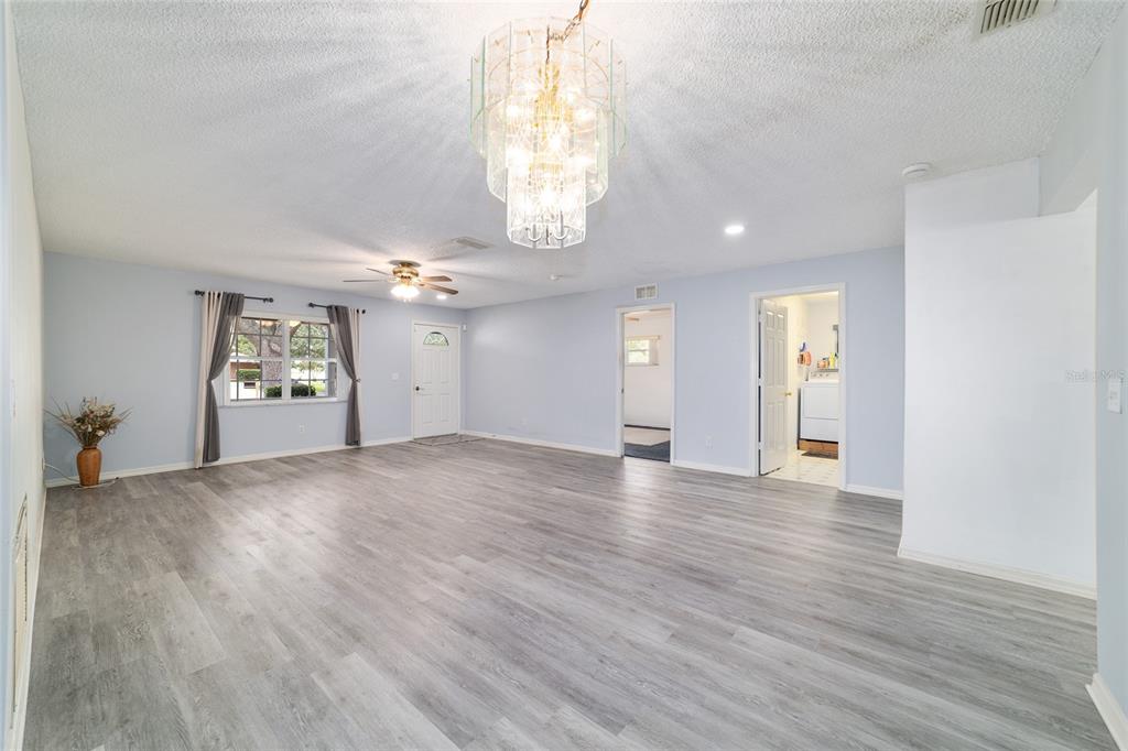 9662 Southwest 97th Lane Ocala, FL 34481 - Photo 12 of 52 an empty room with wooden floor and windows