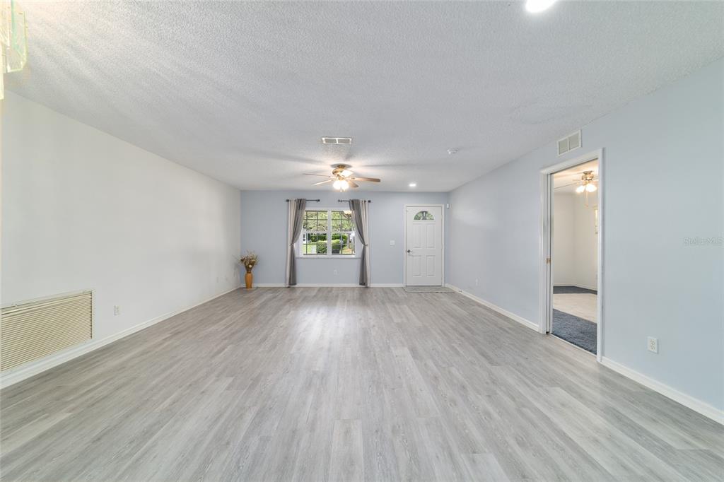 9662 Southwest 97th Lane Ocala, FL 34481 - Photo 13 of 52 wooden floor in an empty room with a window