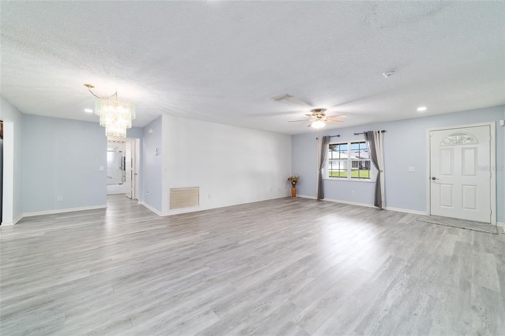 9662 Southwest 97th Lane Ocala, FL 34481 - Photo 14 of 52 a view of empty room with wooden floor and window