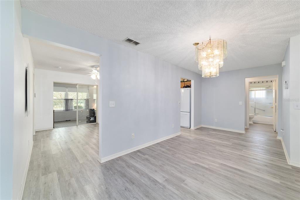 9662 Southwest 97th Lane Ocala, FL 34481 - Photo 19 of 52 wooden floor in an empty room with a mirror