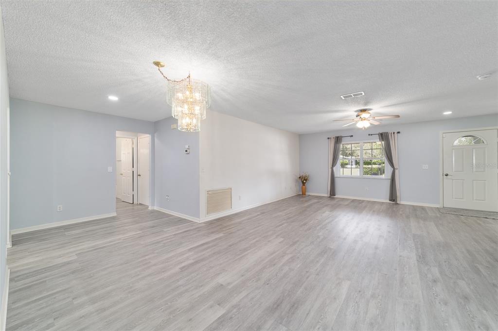9662 Southwest 97th Lane Ocala, FL 34481 - Photo 20 of 52 a view of an empty room with window and wooden floor