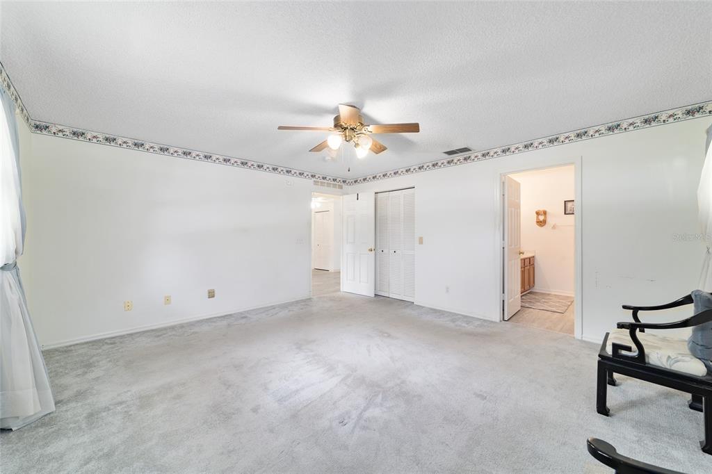 9662 Southwest 97th Lane Ocala, FL 34481 - Photo 32 of 52 a view of a room with a ceiling fan and a rug