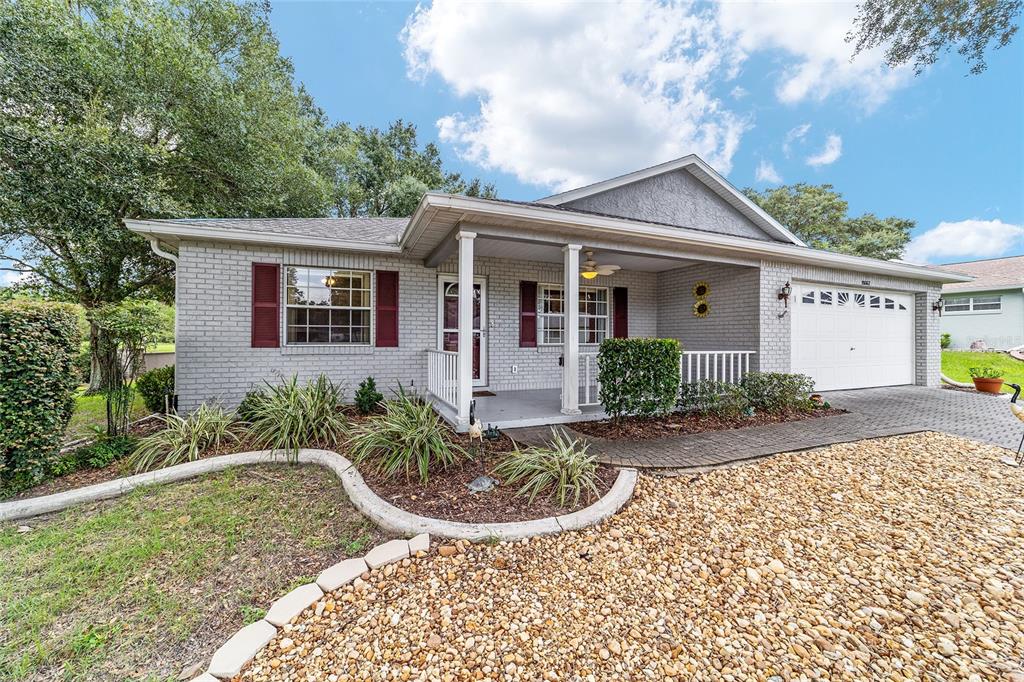 9662 Southwest 97th Lane Ocala, FL 34481 - Photo 4 of 52 a view of a house with a small yard plants and large tree