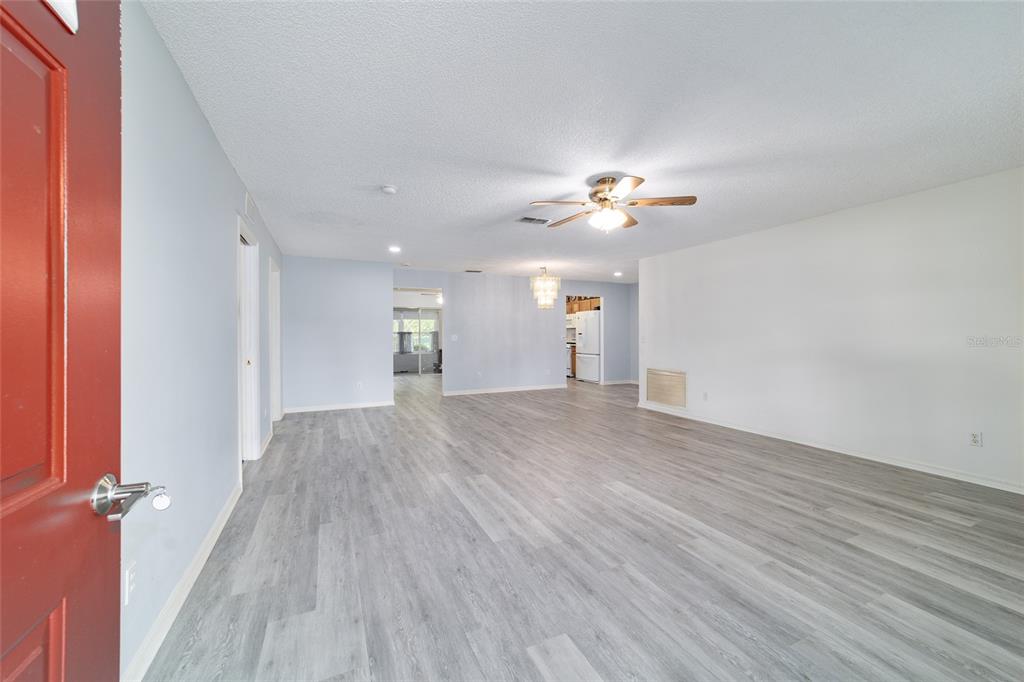 9662 Southwest 97th Lane Ocala, FL 34481 - Photo 7 of 52 wooden floor in an empty room with a window