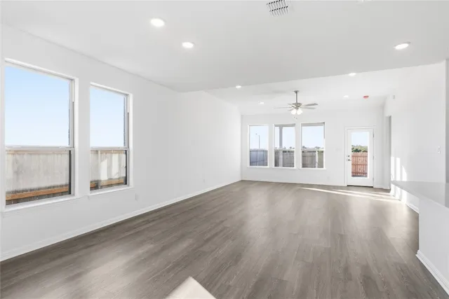 a large kitchen with a large counter top stainless steel appliances and window