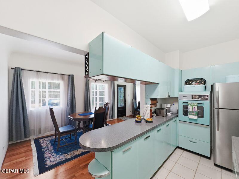 4135 Emory Road El Paso, TX 79922 - Photo 4 of 73 a kitchen with sink a refrigerator and chairs