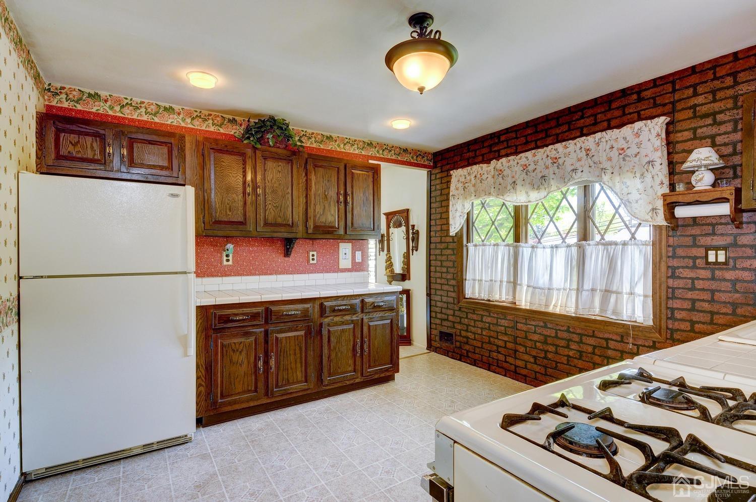 9 Villanova Road Old Bridge, NJ 08859 - Photo 11 of 29 a kitchen with a refrigerator and a stove