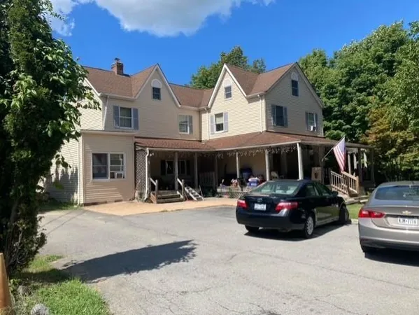 a front view of a house with car parked