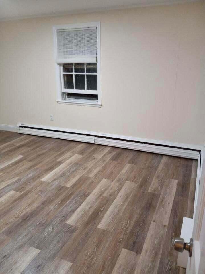 32 Elton Road West Yarmouth, MA 02673 - Photo 11 of 14 a view of an empty room with a window and hardwood floor