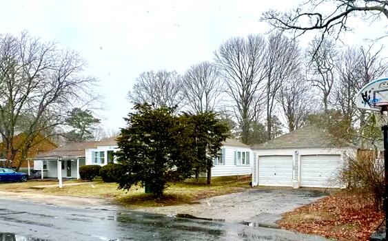 32 Elton Road West Yarmouth, MA 02673 - Photo 2 of 14 a front view of a house with a yard and trees