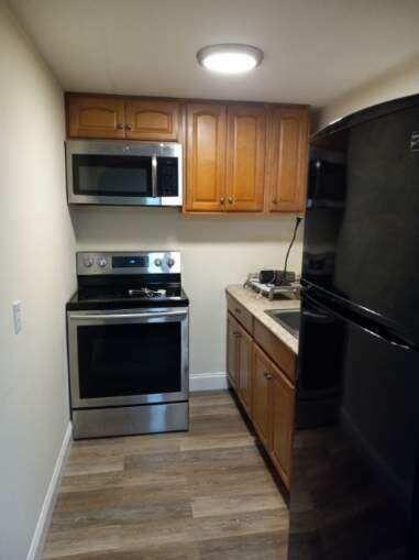 32 Elton Road West Yarmouth, MA 02673 - Photo 10 of 14 a kitchen with granite countertop a stove and a microwave