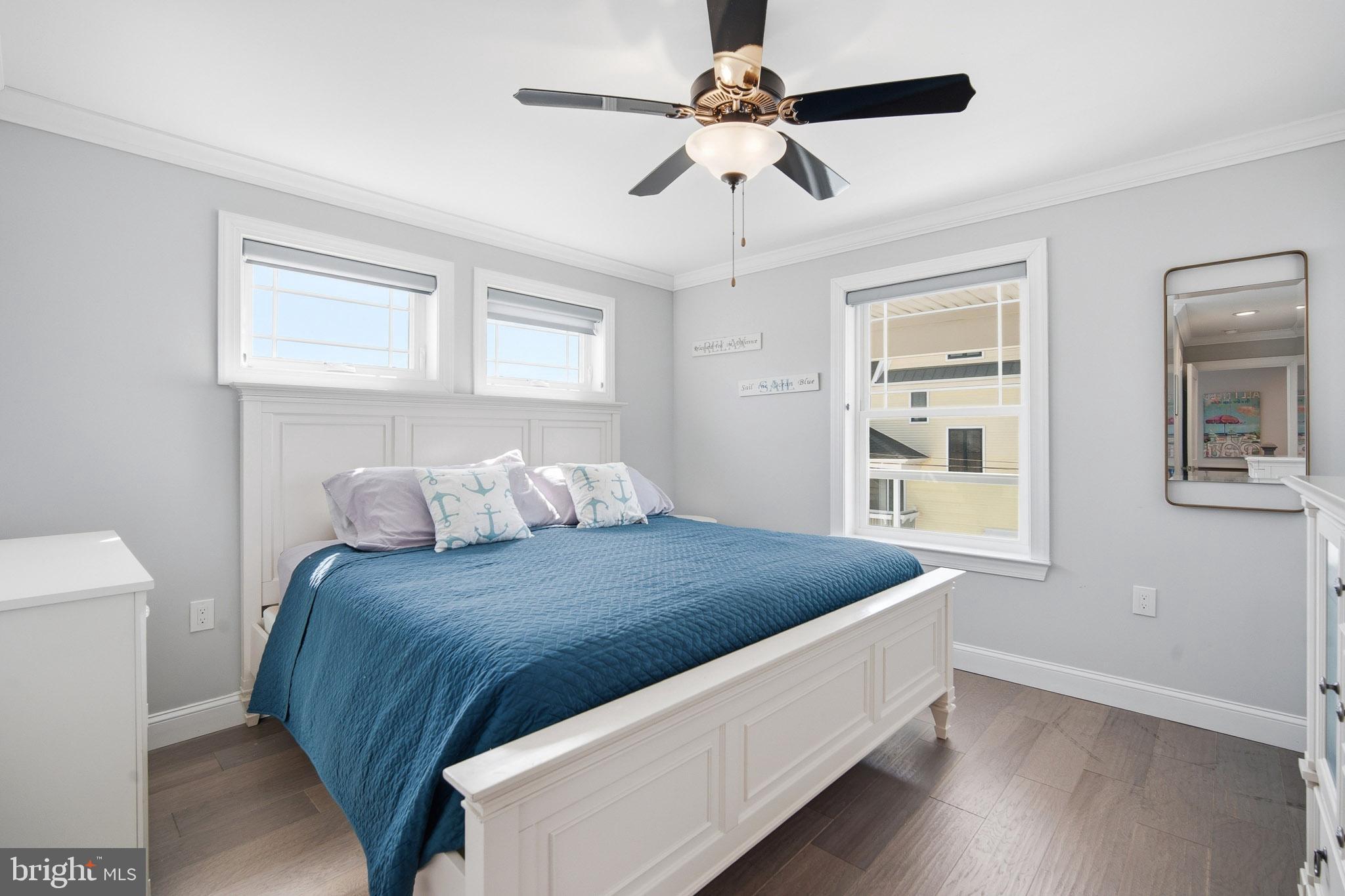 2500 Bayshore Avenue Brigantine, NJ 08203 - Photo 15 of 62 a bedroom with a bed chandelier and a window