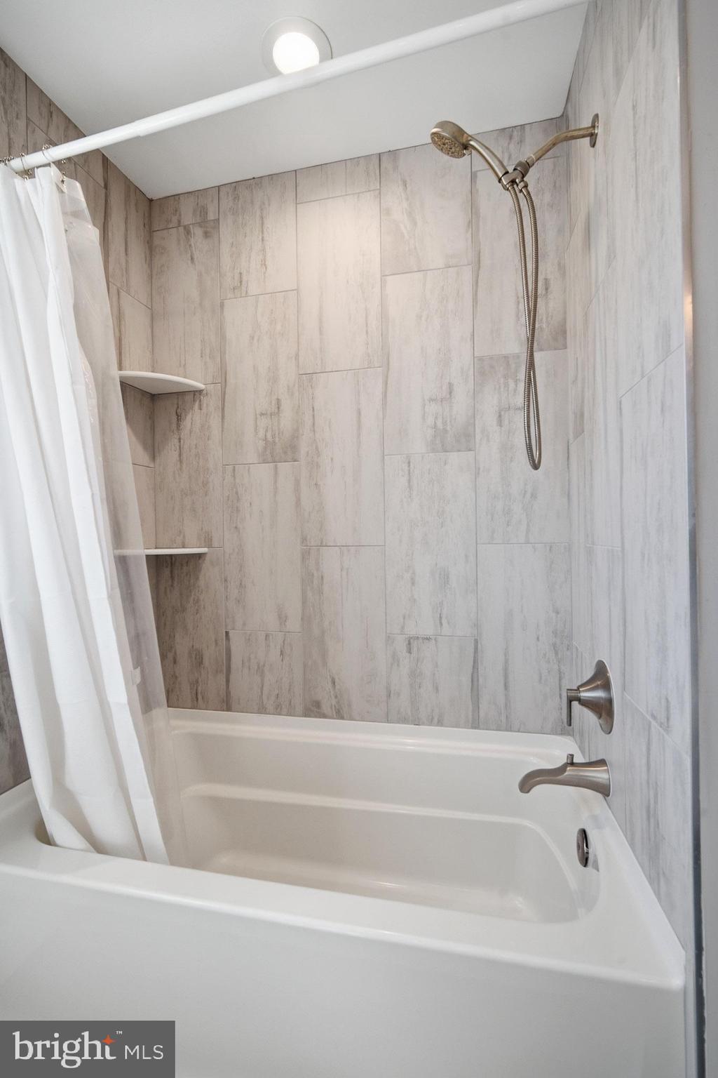 2500 Bayshore Avenue Brigantine, NJ 08203 - Photo 17 of 62 a bathroom with a shower and a bath tub