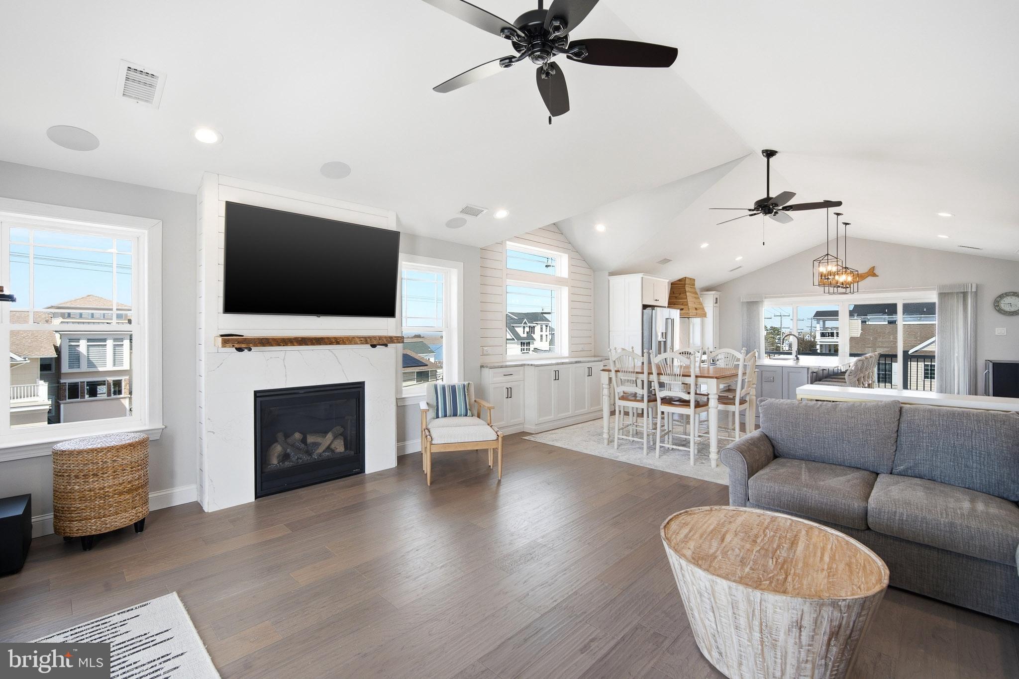 2500 Bayshore Avenue Brigantine, NJ 08203 - Photo 27 of 62 a living room with furniture a fireplace and a flat screen tv