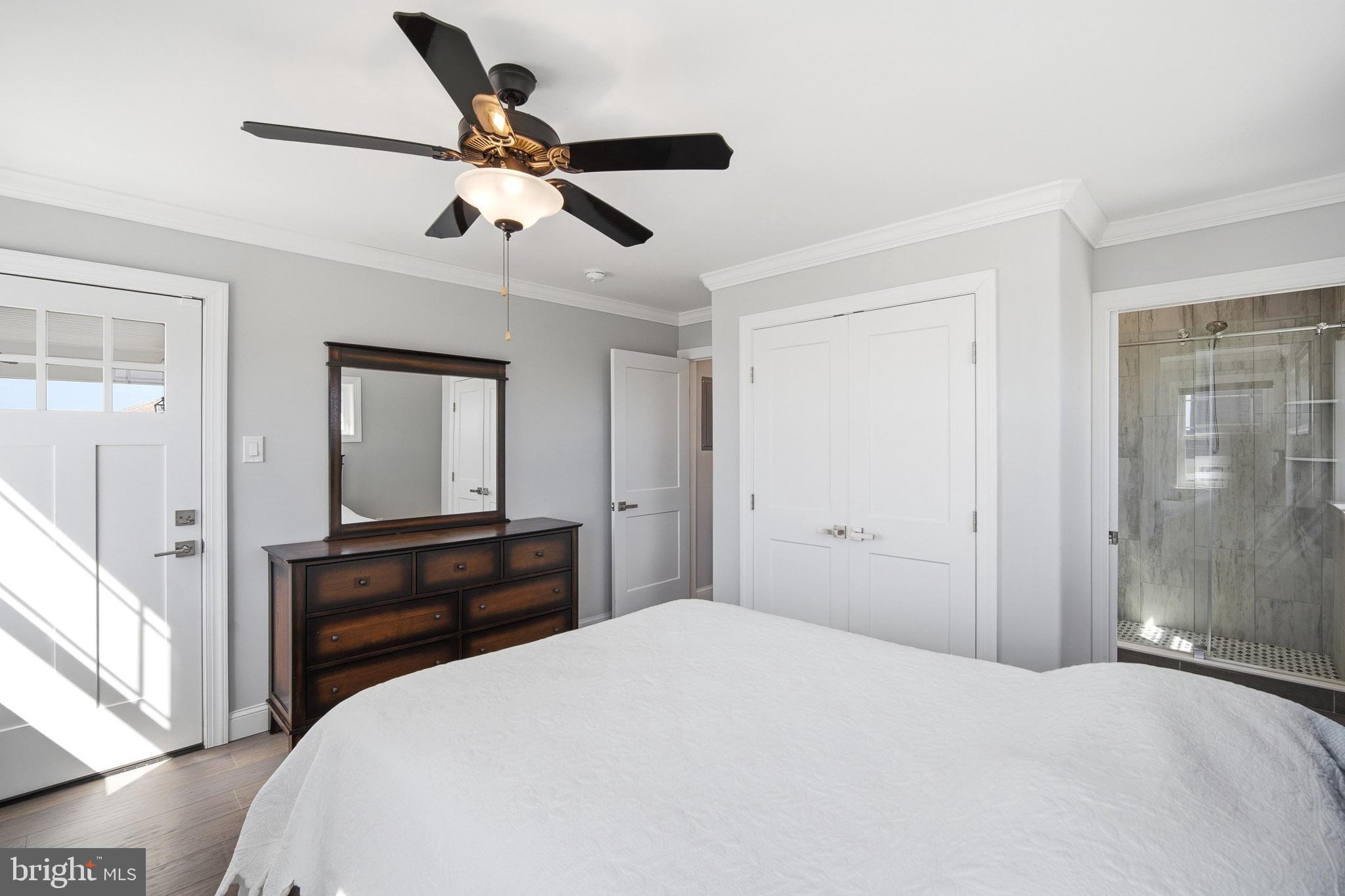 2500 Bayshore Avenue Brigantine, NJ 08203 - Photo 38 of 62 a bedroom with a bed and a chandelier