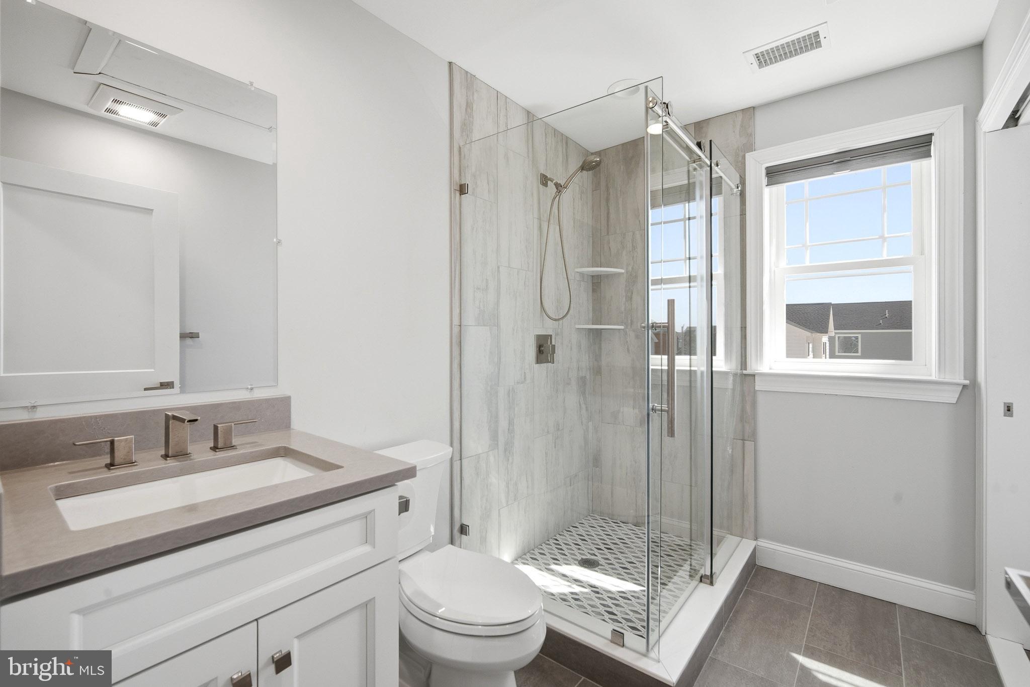 2500 Bayshore Avenue Brigantine, NJ 08203 - Photo 39 of 62 a bathroom with a granite countertop sink toilet and shower