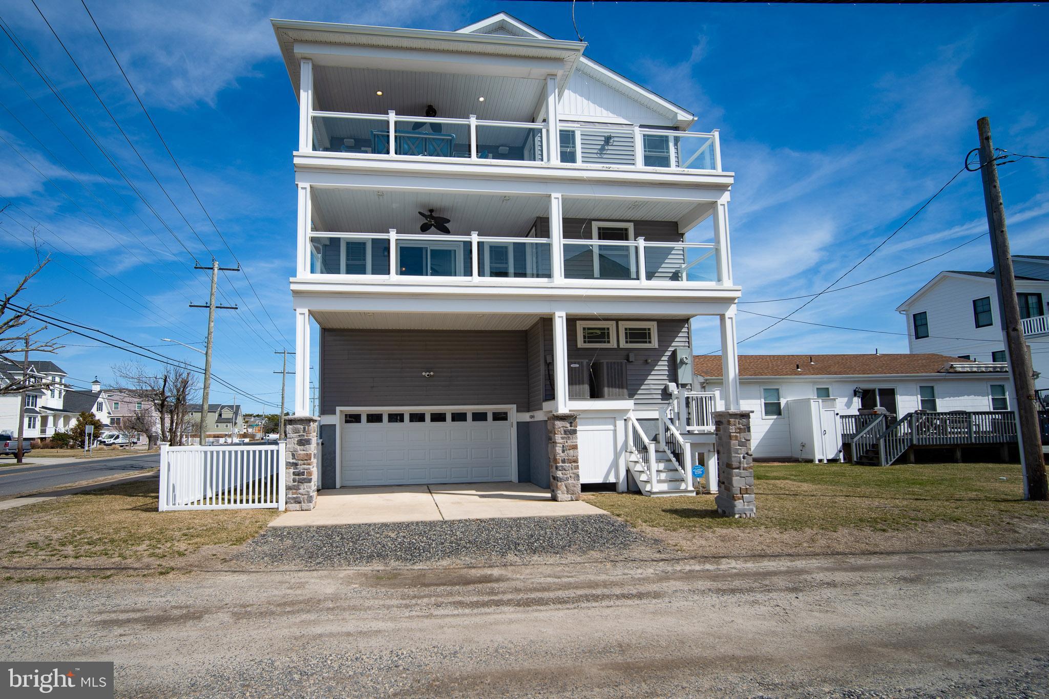 2500 Bayshore Avenue Brigantine, NJ 08203 - Photo 46 of 62 a front view of a building with a yard
