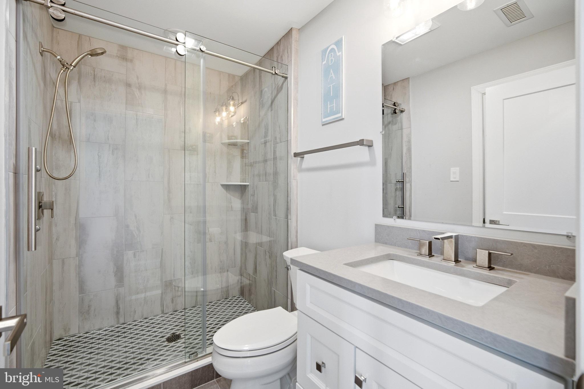 2500 Bayshore Avenue Brigantine, NJ 08203 - Photo 6 of 62 a bathroom with a granite countertop sink toilet and shower