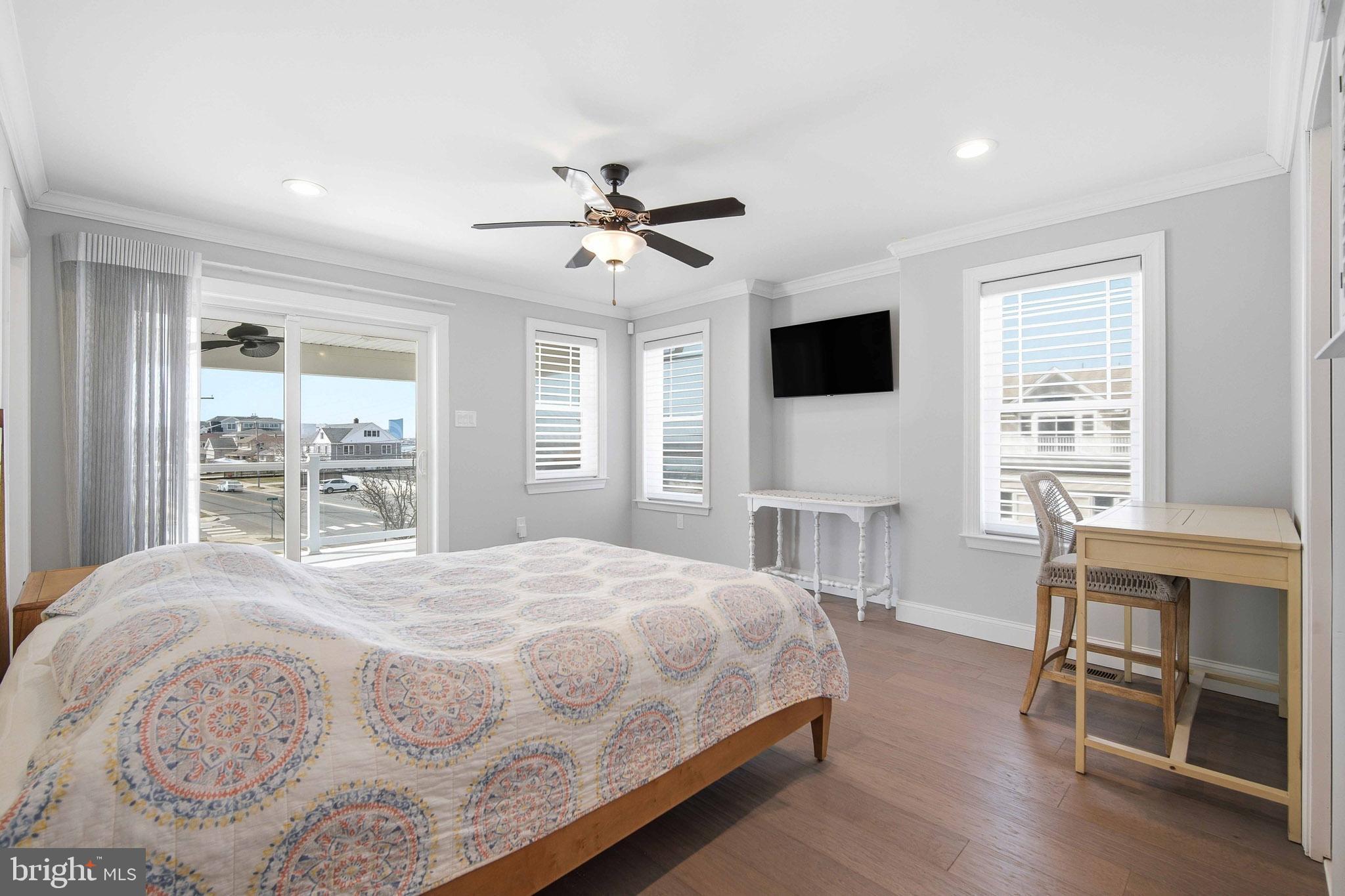 2500 Bayshore Avenue Brigantine, NJ 08203 - Photo 8 of 62 a bedroom with a large bed a flat tv screen and chair