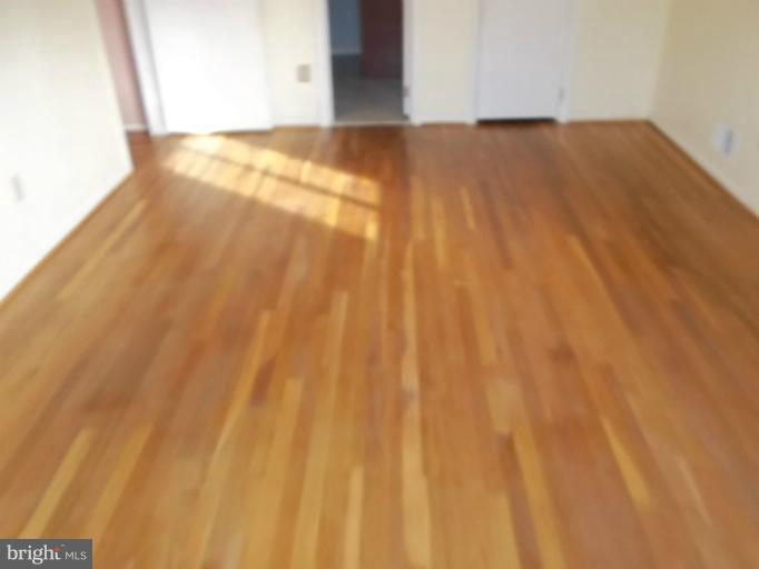 12803 Broadmore Road Silver Spring, MD 20904 - Photo 3 of 11 a view of an empty room and wooden floor