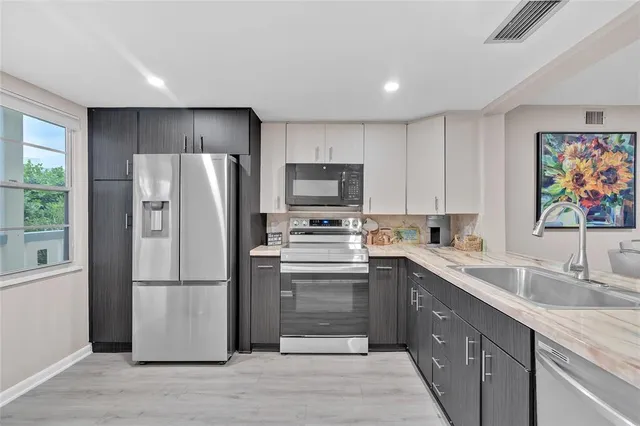 a kitchen with a refrigerator sink and microwave