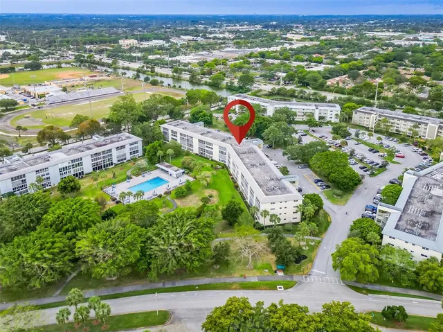 an aerial view of residential houses with outdoor space and river