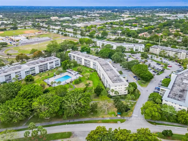 an aerial view of residential houses with outdoor space and river
