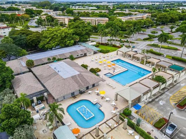 an aerial view of a house with a swimming pool yard and outdoor seating