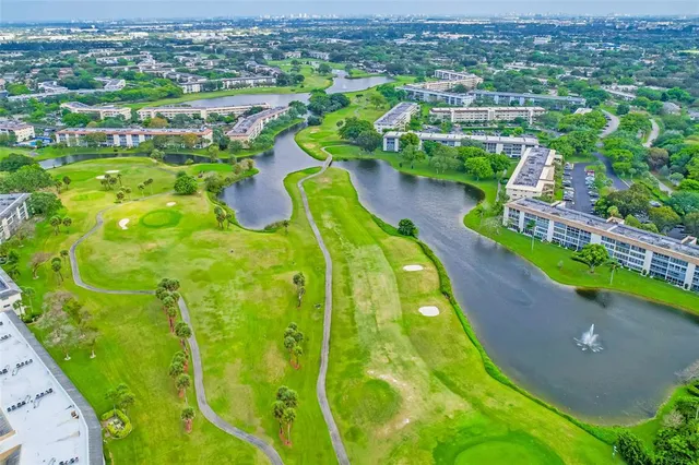 an aerial view of residential houses with outdoor space and swimming pool