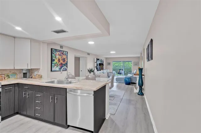 a kitchen with sink cabinets and window