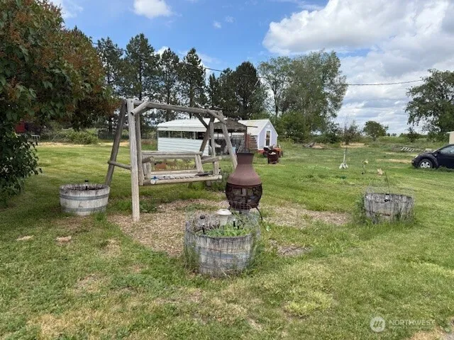 a backyard of a house with table and chairs