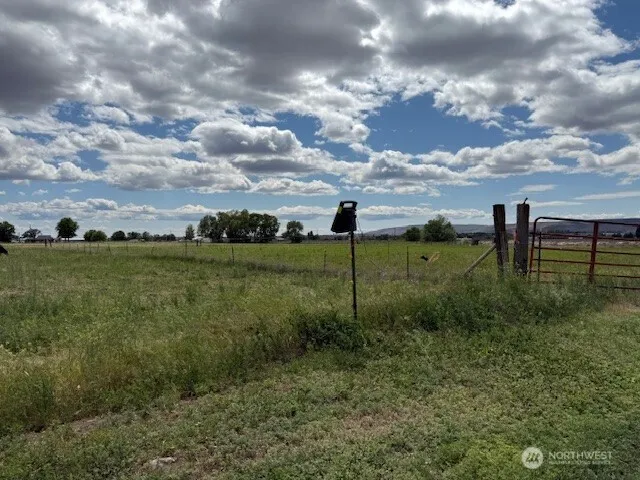 a view of a big yard with table and chairs