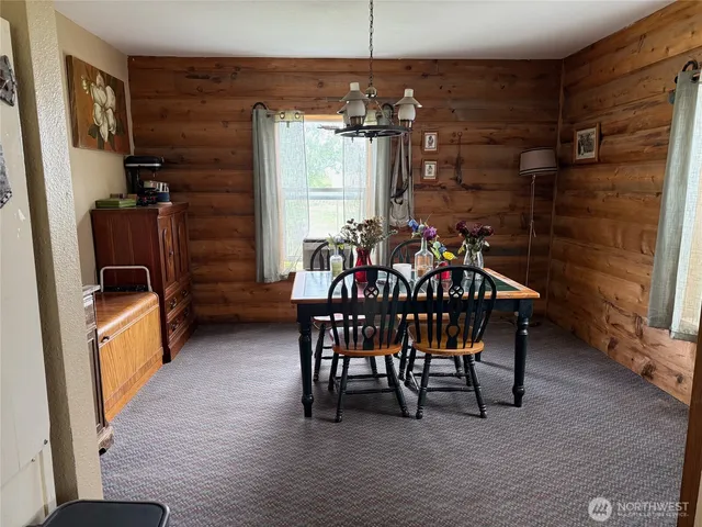a view of a dining room with furniture and chandelier