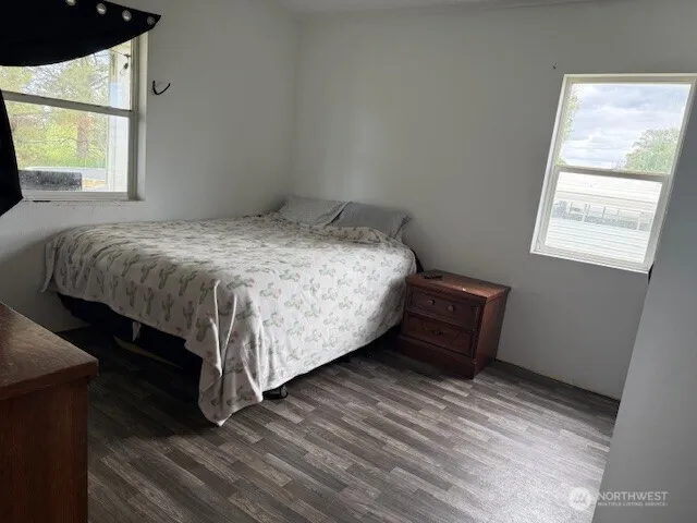 a bed sitting in a bedroom next to a window