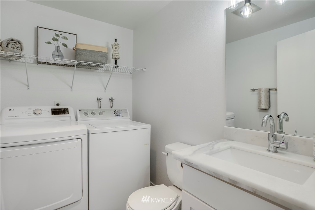 4114 Northeast 5th Street Renton, WA 98059 - Photo 11 of 20 a bathroom with a sink a toilet and a mirror