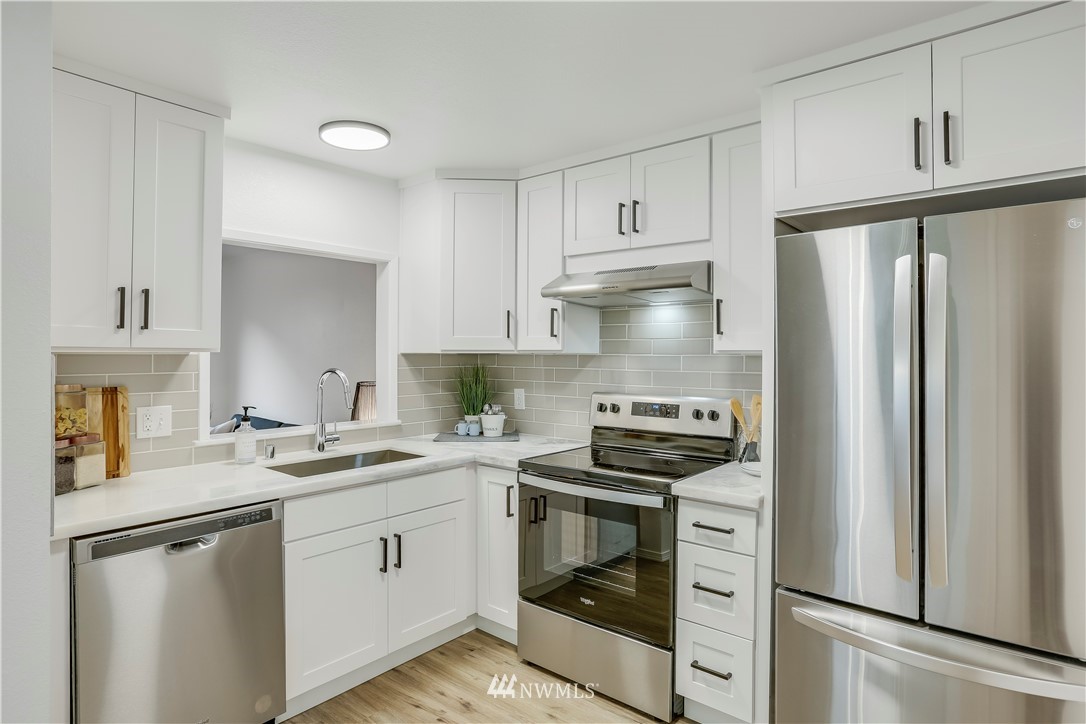4114 Northeast 5th Street Renton, WA 98059 - Photo 9 of 20 a kitchen with a stove sink and refrigerator