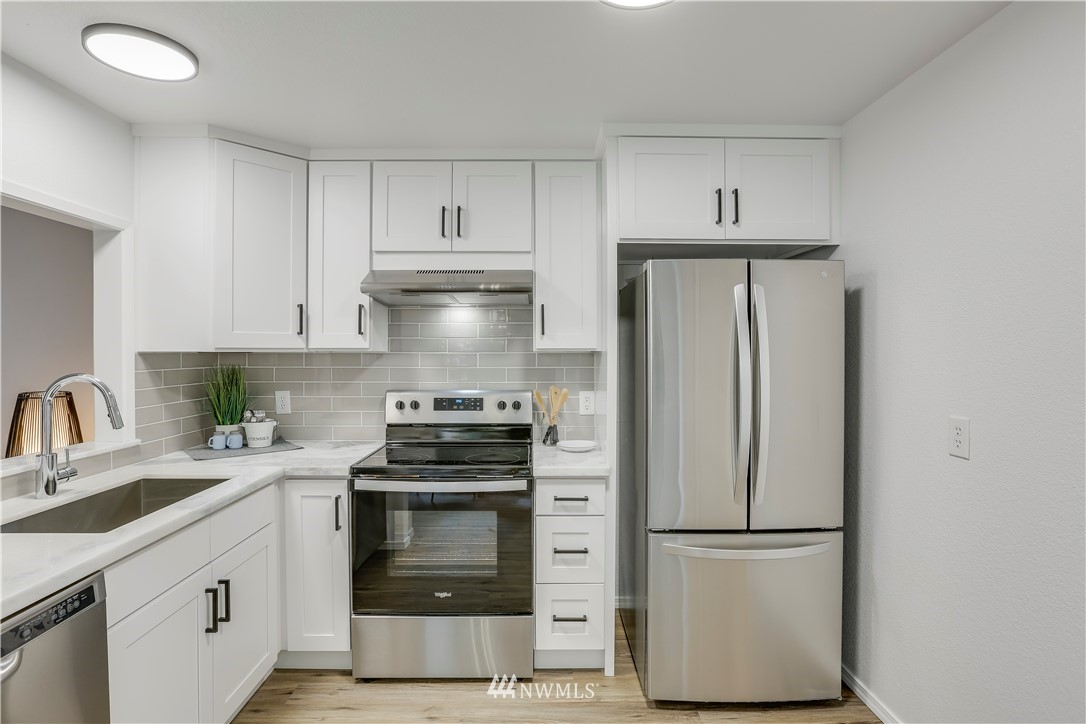 4114 Northeast 5th Street Renton, WA 98059 - Photo 10 of 20 a kitchen with a white stove and white cabinets