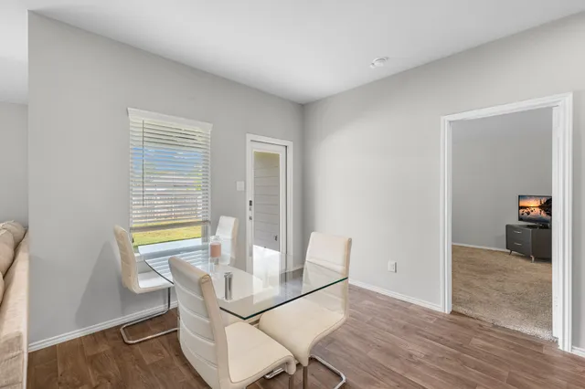 a view of a dining room with furniture and a window